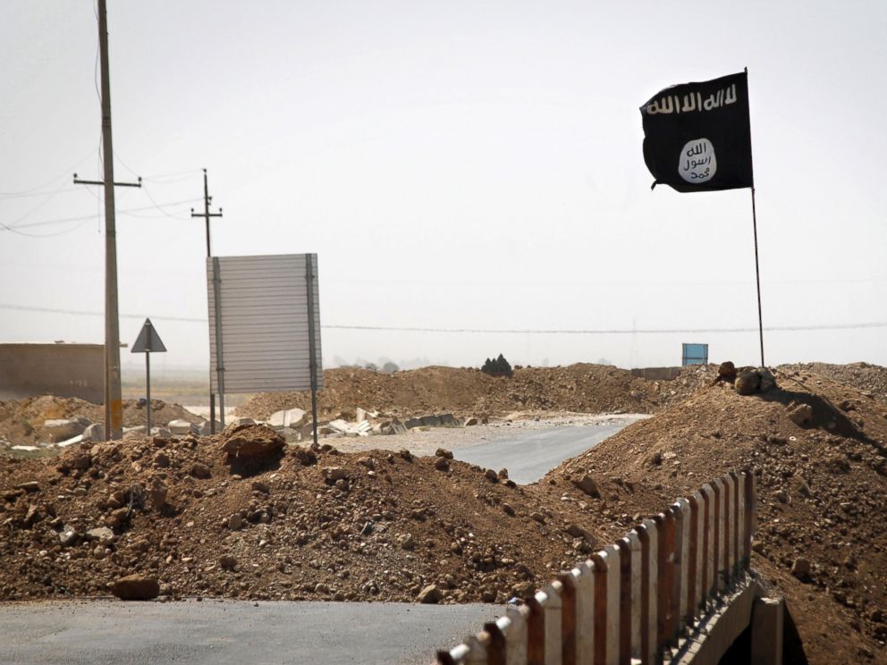 PHOTO: A flag of the Islamic State is seen on the other side of a bridge at the front line of fighting between Kurdish Peshmerga fighters and Islamist militants in Rashad, on the road between Kirkuk and Tikrit, Sept. 11, 2014.