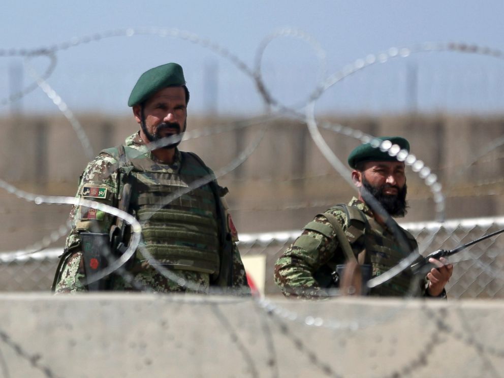 PHOTO: Afghanistan National Army soldiers stand guard at a gate of Camp Qargha, west of Kabul, Afghanistan, Aug. 5, 2014. 