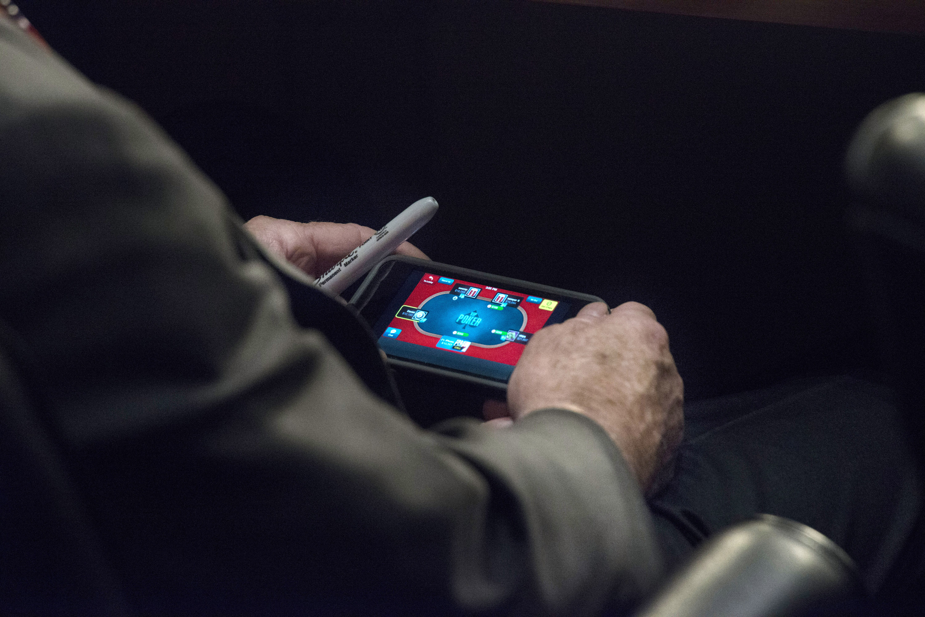 Senator John McCain plays poker on his IPhone during a U.S. Senate Committee on Foreign Relations hearing where Secretary of State JohnKerry, Secretary of Defense Chuck Hagel, and Chairman of the Joint Chiefs of Staff General Martin Dempsey testify concerning the use of force in Syria, on Capitol Hill in Washington DC, Tuesday, September 3, 2013. (Photo by Melina Mara/The Washington Post) 