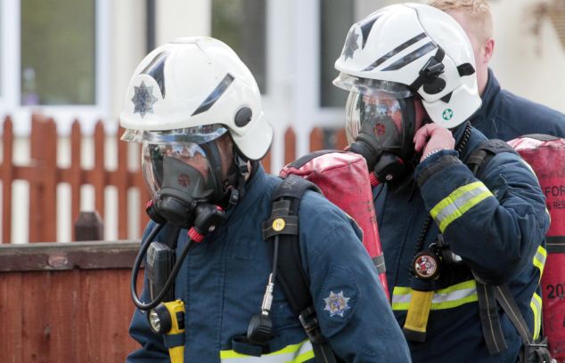 Fear: Two men were arrested by anti-terrorism officers and bomb disposal experts, pictured, carried out explosions at a cordoned-off garage