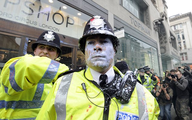 A policeman splashed with paint in Oxford Street during the anti-cuts protest