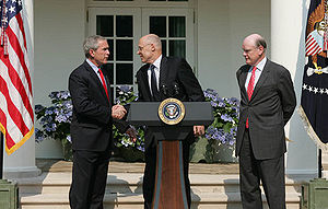 President George W. Bush shakes the hand of He...