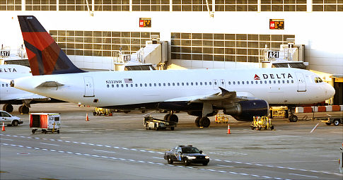 A police car patrols the plane that was almost brought down Friday in a foiled terror attack.