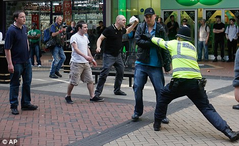 A man with a Union Jack flag is attacked after the protest sparked violence