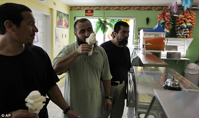 Khelil Mamut, Ablakim Turahun, and Salahidin Abdulahat (left to right) enjoy butter pecan ice cream at a local Hamilton shop