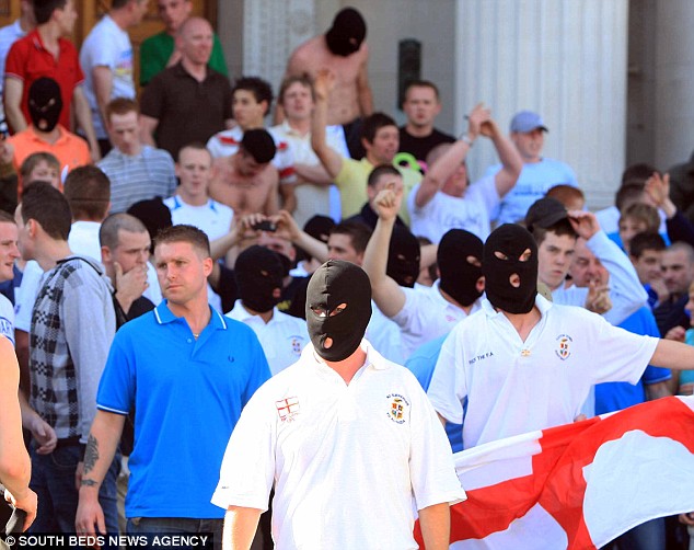 Looking for trouble: Protesters in Luton's city centre yesterday stormed the streets wearing balaclavas and clashed with police