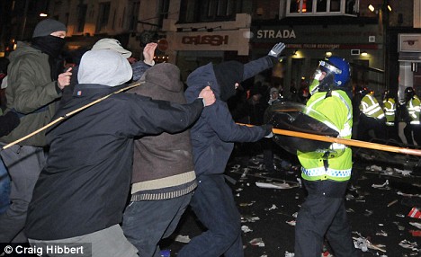 Police try and hold back the protesters outside the Israeli embassy, Kensington, as thousands show their anger at the worsening situation in Gaza